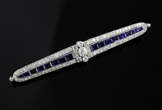 An Art Deco white gold?, sapphire and diamond bar brooch, 7.7cm.